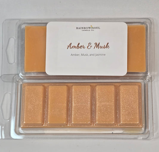 Amber-colored wax melt snap bars with a label on a white background