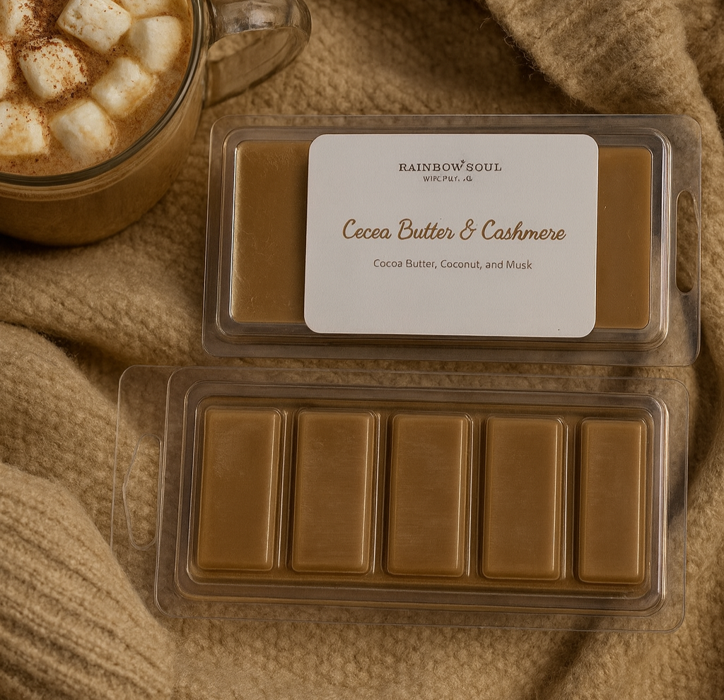 Two packages of Cocoa Butter & Cashmere snap bar wax melts on a textured beige fabric background with a cup of hot chocolate.