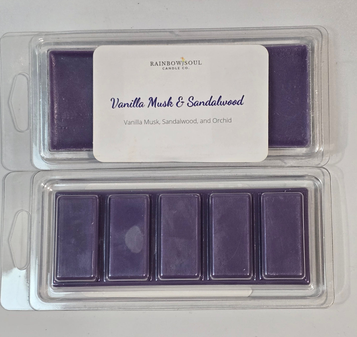 Purple wax melt snap bars in a clear plastic container with a label on a white background