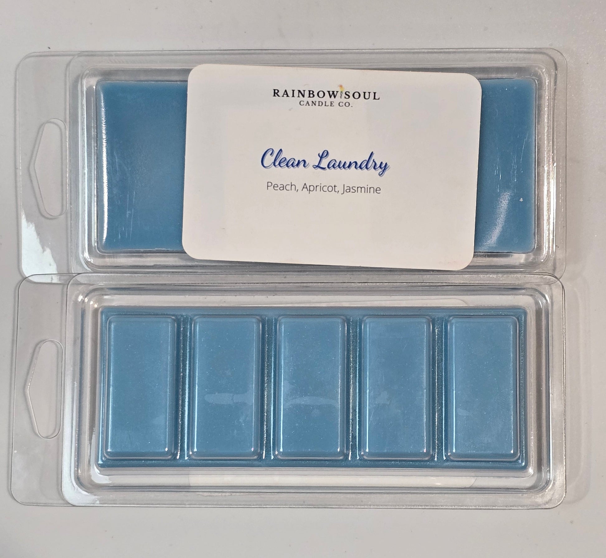 Blue snap bar wax melts in a packaging tray with a label on a gray background