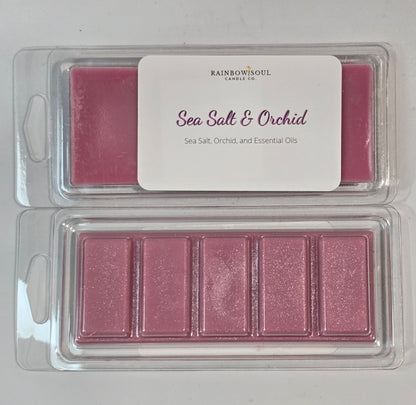 Pink wax melt snap bars in a clear container with a label on a light gray background